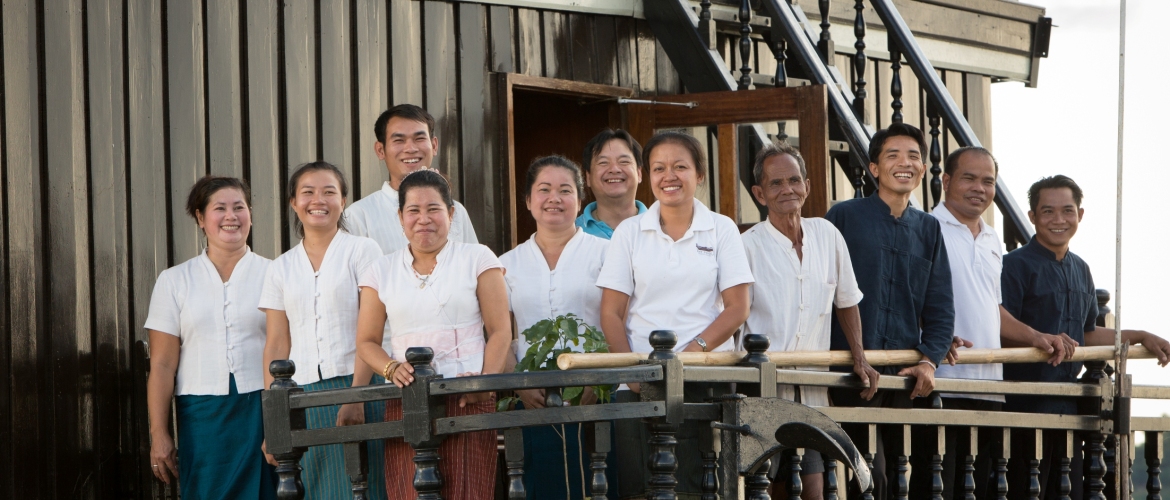 Staff on board the Vat Phou boat, a floating hotel cruising on the Mekong River, southern Laos